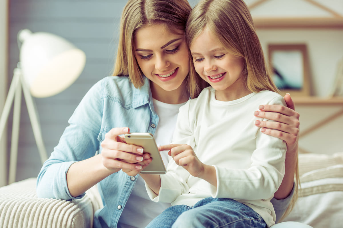 bambina ragazza divano sorriso smartphone cellulare
